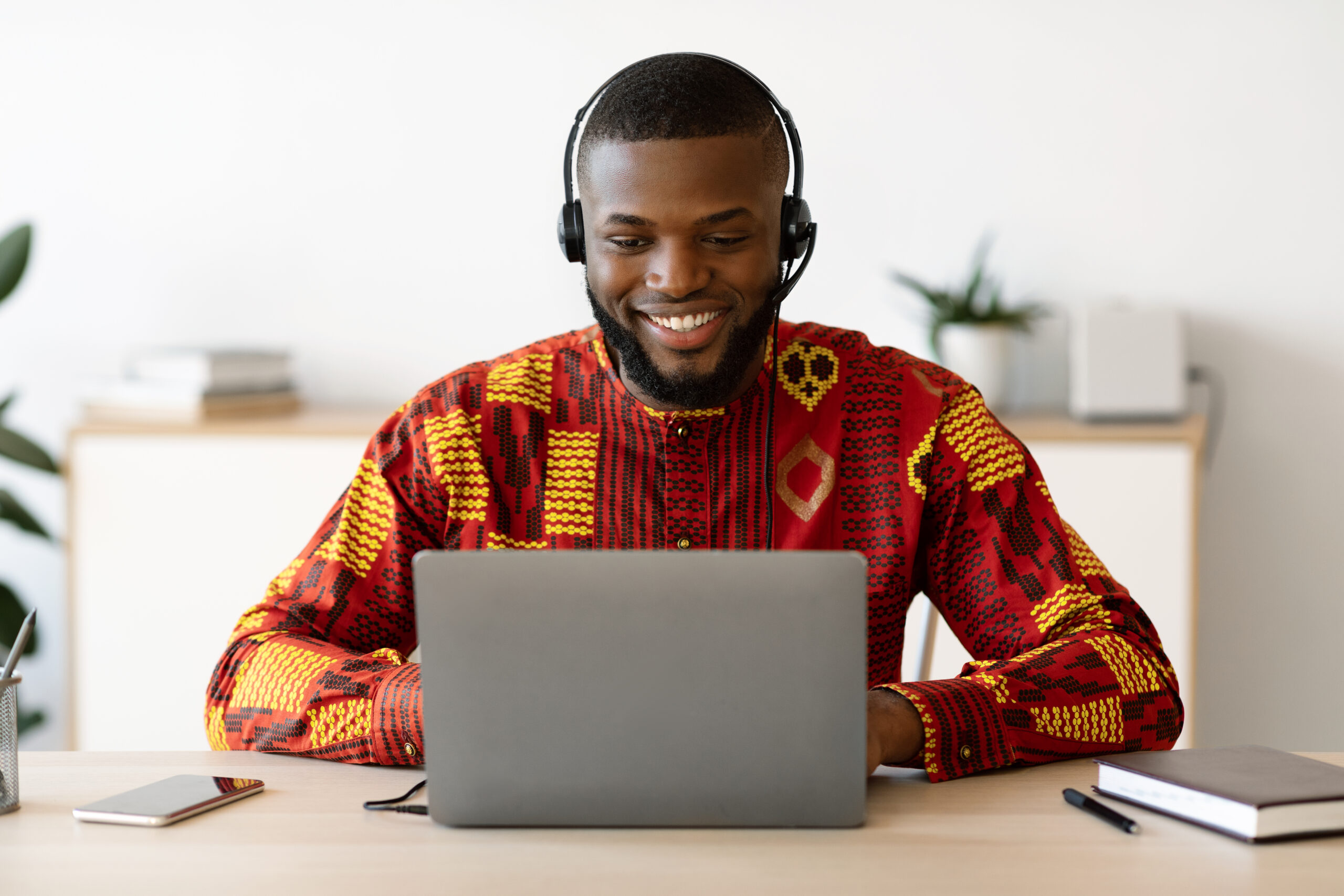 Distance,Education.,Smiling,Black,Man,In,African,Shirt,And,Headset